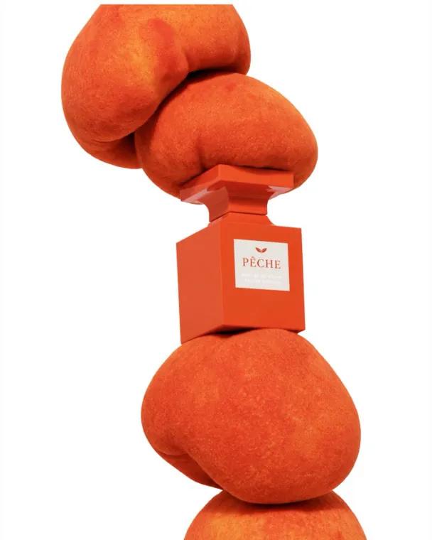 Product spotlight: a perfume bottle held in sculpted orange forms